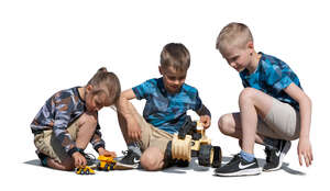 three cut out boys playing with toy cars