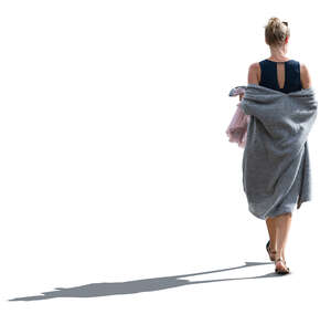 cut out backlit woman with a grey summer overcoat walking