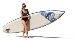 cut out woman with a sup board walking on the beach