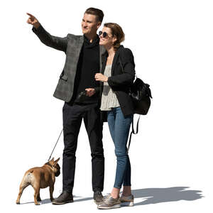 couple with a dog standing and looking at smth