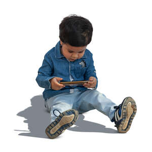 cut out little boy sitting on the ground with a smartphone in his hand