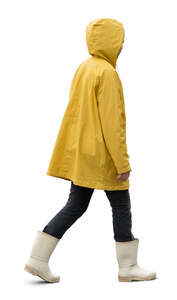 cut out woman in a yellow rain coat walking
