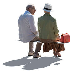 two cut out backlit elderly people sitting and talking