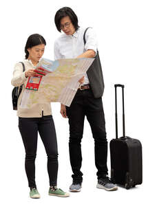 cut out asian tourists standing and looking at a city map