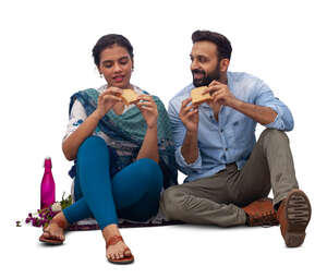 cut out indian man and woman sitting and eating sandwiches