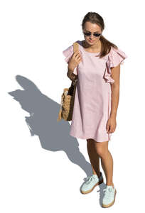 cut out woman in a pink summer dress standing seen from above