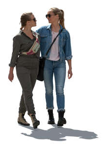 two cut out backlit women walking arm in arm 