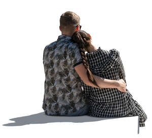 cut out backlit couple sitting and holding each other