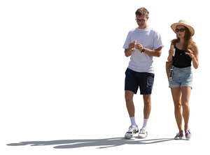 cut out backlit man and woman walking and eating ice cream