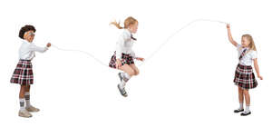 three cut out schoolgirls playing with jumping rope 