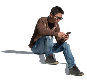 cut out man sitting on the stairs with a phone in his hand