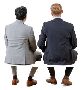 two cut out businessmen sitting seen from behind