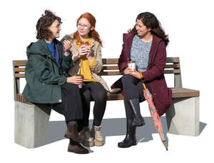 three cut out women sitting and talking in autumn