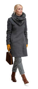 cut out woman in a grey overcoat walking