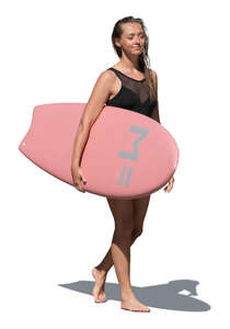 cut out woman with a surfboard walking on the beach