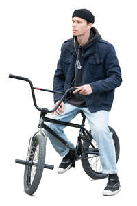 cut out young man with a bmx bike taking a break