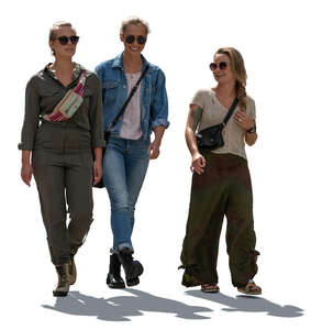 three cut out backlit women walking and talking cheerfully