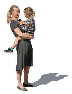 woman standing and holding her toddler child