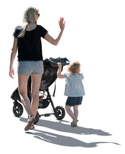 backlit image of a mother and daughter walking