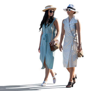 two backlit women walking and talking