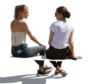 two cut out  women sitting and talking seen from behind