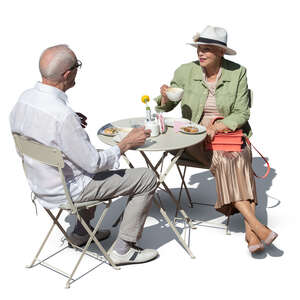 cut out elderly couple drinking coffee in a cafe seen from above