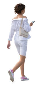 cut out woman in a white summer outfit walking