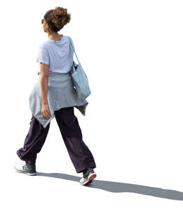 cut out backlit woman walking seen from above