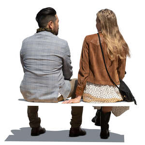 two cut out people sitting seen from behind