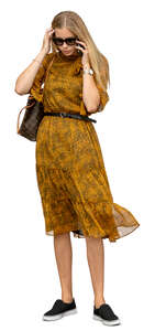 cut out woman in a dress standing and talking on a phone