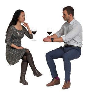 cut out man and woman sitting in a restaurant and drinking wine