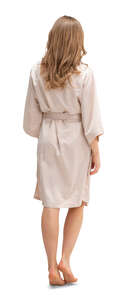 cut out woman in a beige silky bathrobe walking