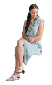 cut out woman in a pale blue dress sitting