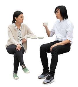 cut out asian man and woman sitting in a cafe and talking