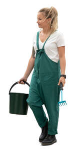 cut out gardener with a bucket and rake walking