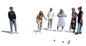 cut out group of young adults playing petanque