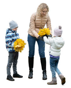 two cut out kids and their mother picking leaves in the park