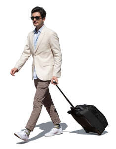 cut out handsome man with a suitcase walking on sunny day