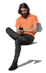 cut out man sitting and typing on his phone