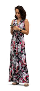 cut out woman in a long dress standing and looking at her phone