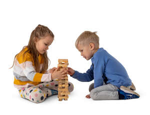 two cut out kids playing on the floor with some wooden toys