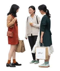three cut out young asian women standing and talking