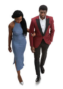 cut out black couple walking arm in arm at a forma event seen from above