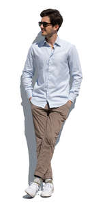 cut out man standing and leaning casually against the wall with hands in his pockets