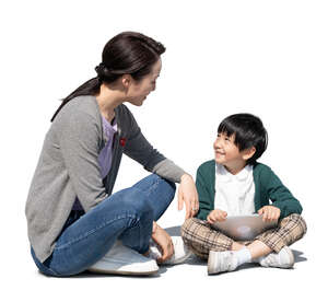cut out mother and son sitting on the ground and talking