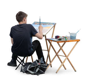 cut out young man sitting and painting