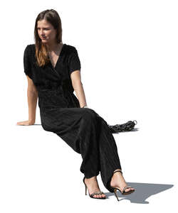 cut out woman in a black jumpsuit sitting