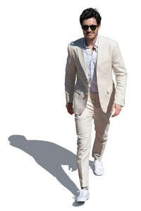 cut out man in a white suit walking seen from above