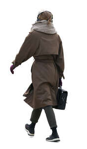 cut out woman in a brown overcoat walking