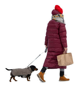 cut out woman in a puffer winter jacket walking a dog